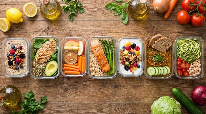 7-day clean eating meal plan prep in glass containers with healthy whole foods.