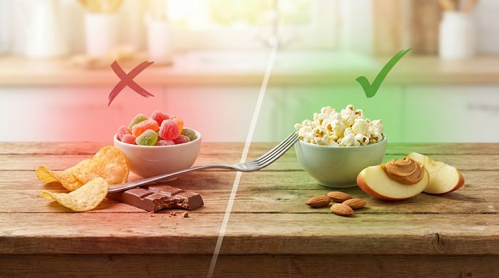 Eat This Not That chart comparing unhealthy chips and candy to healthy popcorn and almonds for weight loss.
