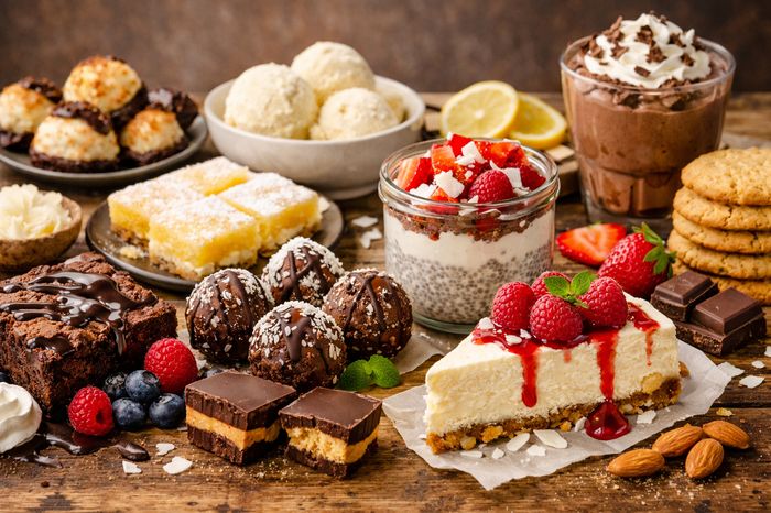 Delicious guilt-free keto desserts including cheesecake, fudgy brownies, and fat bombs on a table.